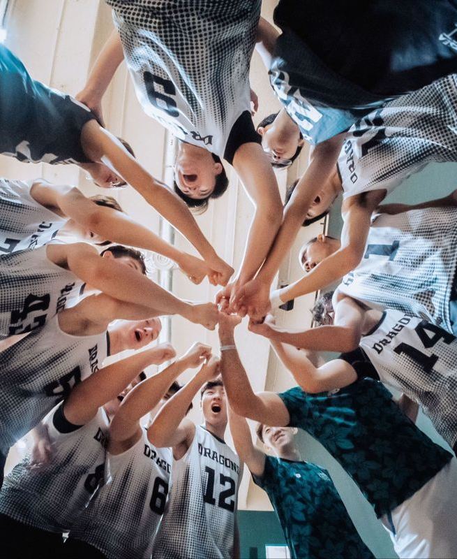Volleyball team stacking hands in a huddle